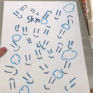 It has clouds and it is blue and hand made piece of paper.